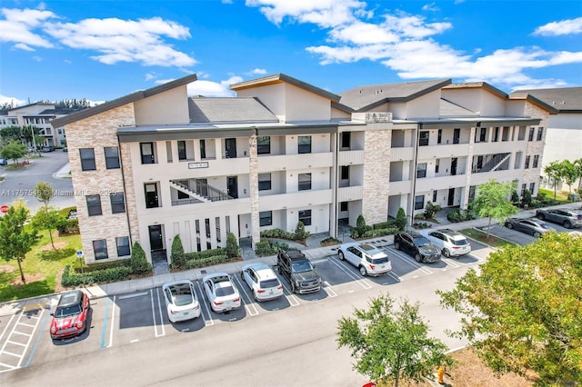 view of property featuring uncovered parking