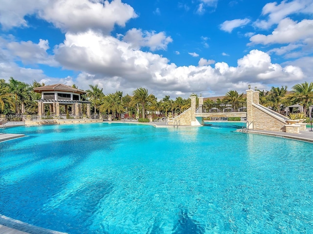 pool featuring a water slide and fence