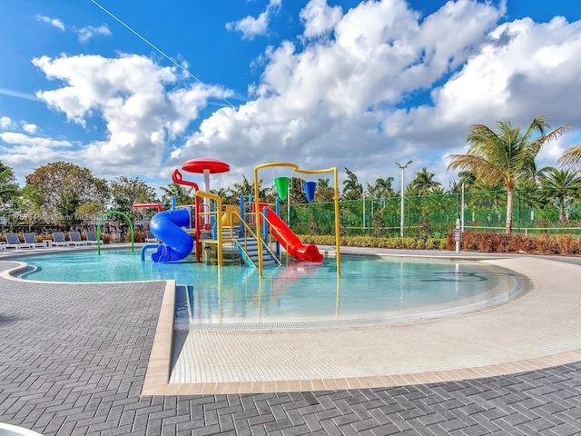 community playground featuring fence and a water play area