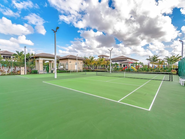 view of tennis court with fence