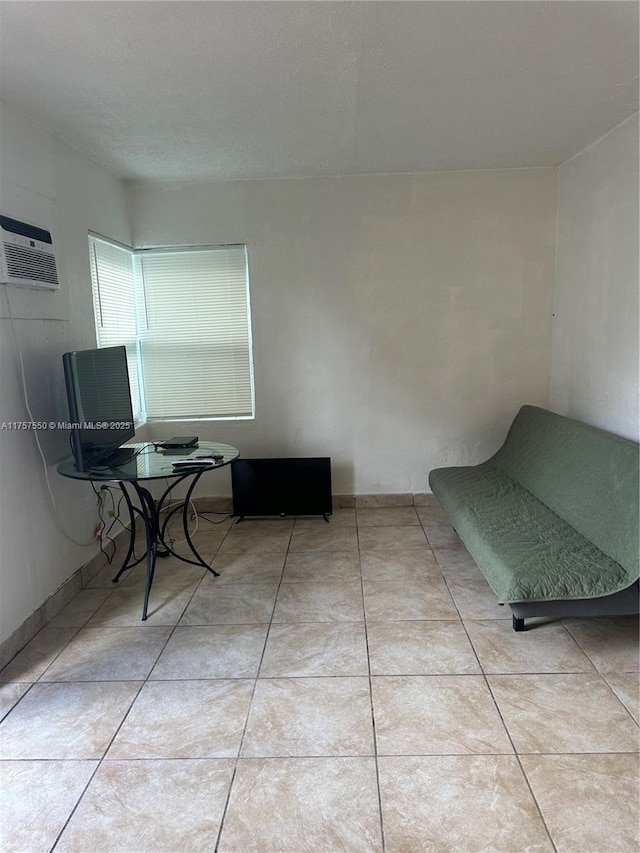 interior space featuring an AC wall unit and tile patterned floors