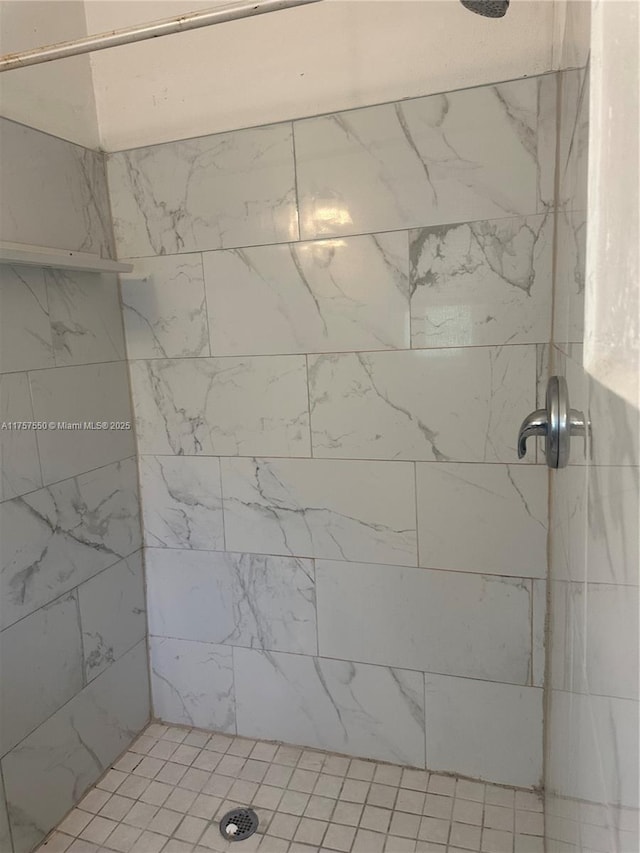 bathroom with a tile shower