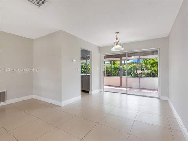 spare room with light tile patterned floors, visible vents, and baseboards