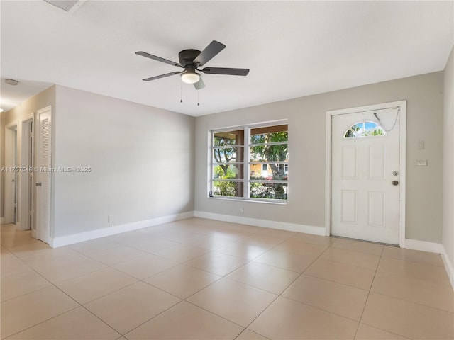 entrance foyer with ceiling fan, light tile patterned floors, and baseboards