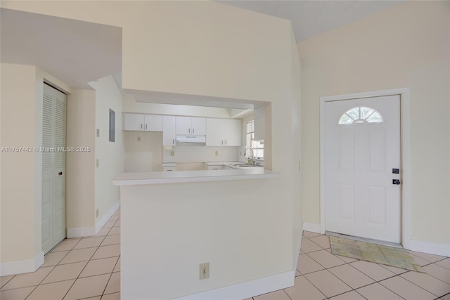 entryway featuring light tile patterned floors and baseboards