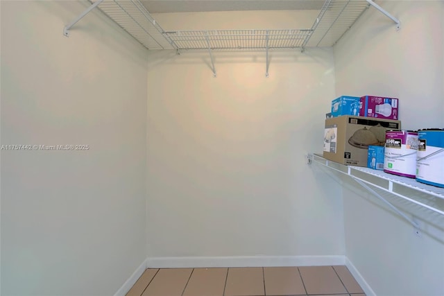 spacious closet with light tile patterned floors