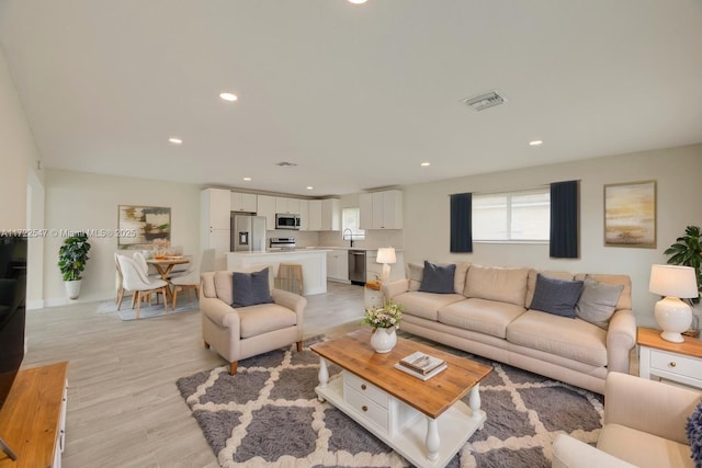 610 N 31st Ct, Hollywood, FL 33021 - living room featuring recessed lighting and light wood-style flooring