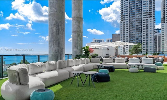 view of patio / terrace with a view of city, outdoor lounge area, and a water view