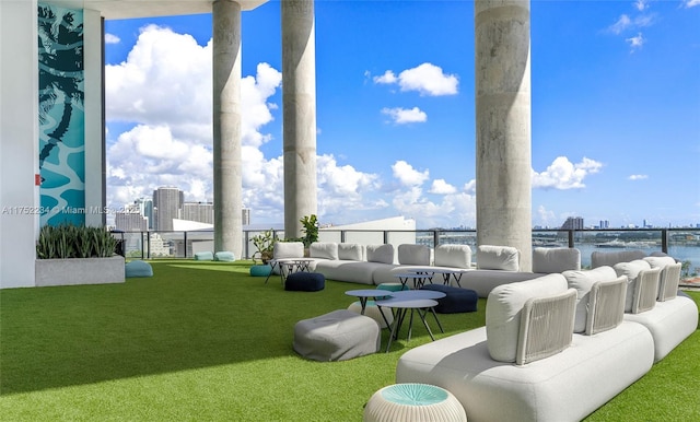 view of patio featuring a water view, outdoor lounge area, and a city view