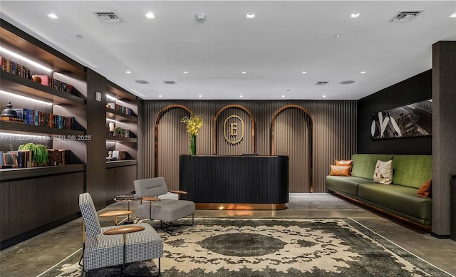 interior space featuring concrete flooring, built in shelves, visible vents, and recessed lighting