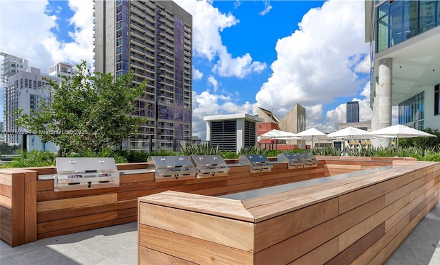 exterior space with exterior kitchen, area for grilling, and a city view