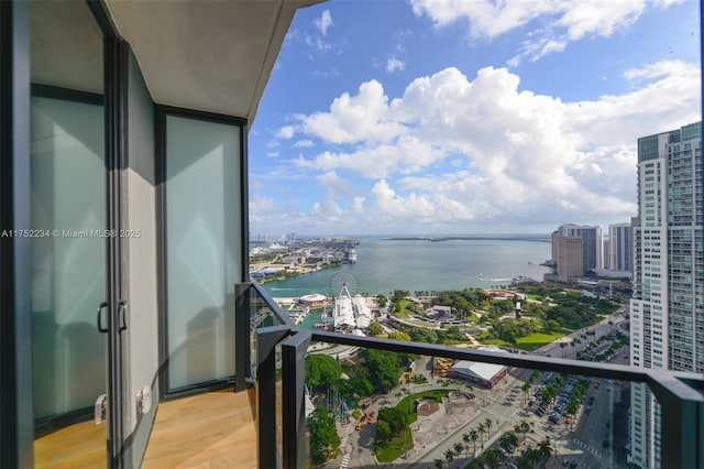 balcony featuring a water view and a view of city