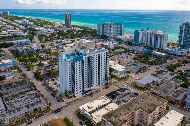 birds eye view of property featuring a view of city and a water view