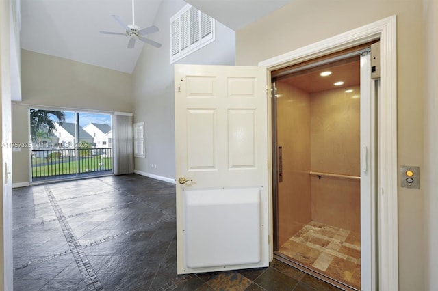 interior space featuring visible vents, a ceiling fan, elevator, high vaulted ceiling, and baseboards