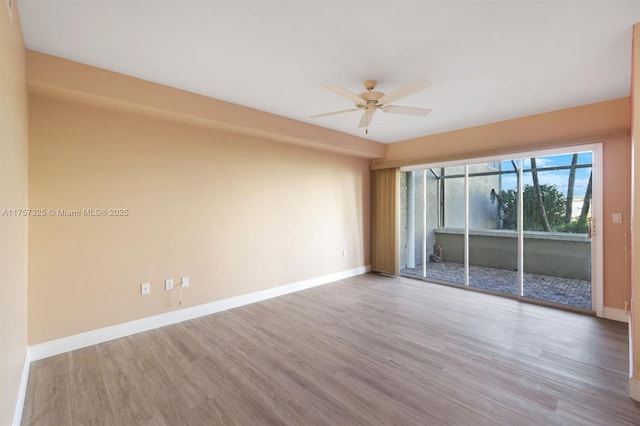 unfurnished room featuring ceiling fan, wood finished floors, and baseboards