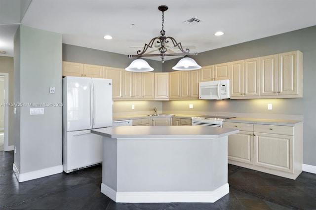 kitchen featuring white appliances, baseboards, visible vents, a kitchen island, and light countertops