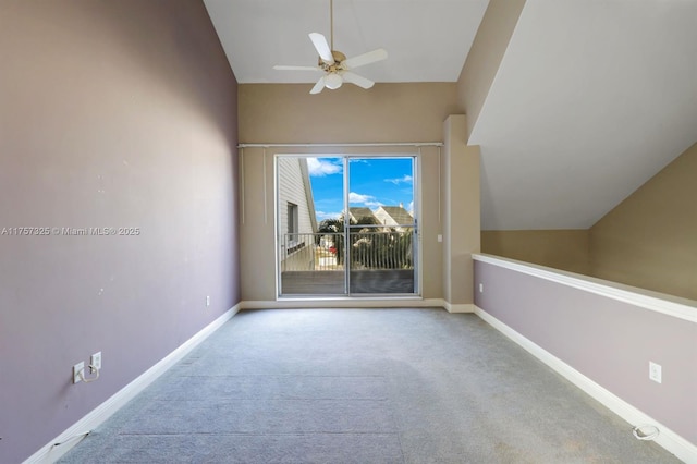 unfurnished room featuring lofted ceiling, carpet, baseboards, and a ceiling fan