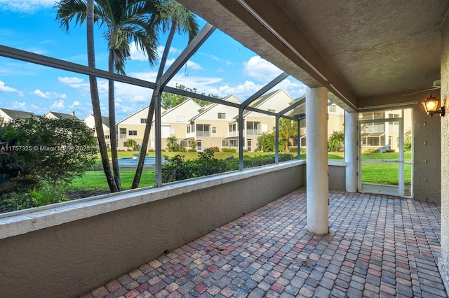 view of patio featuring a residential view and a lanai