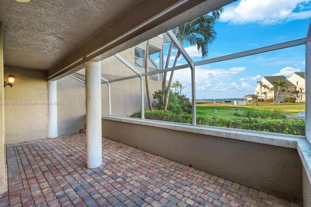 view of patio with glass enclosure