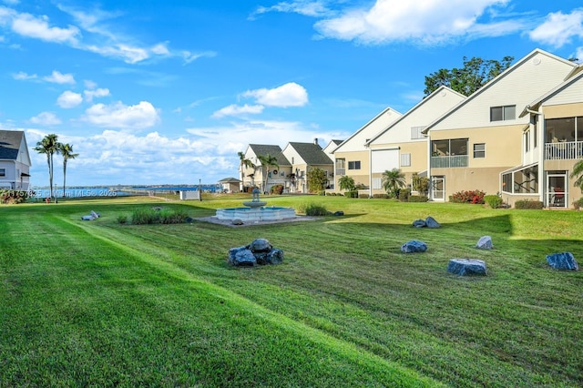 view of property's community with a residential view and a lawn