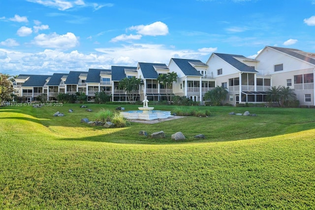 view of property's community featuring a residential view and a lawn