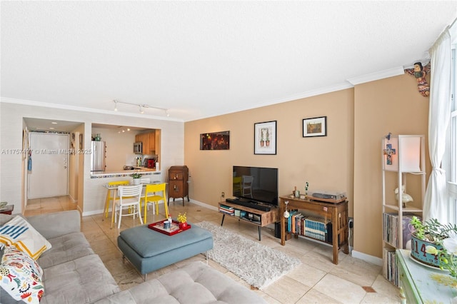 living area featuring a textured ceiling, ornamental molding, light tile patterned flooring, and baseboards