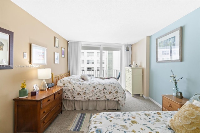 carpeted bedroom featuring baseboards