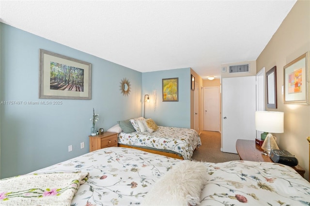 carpeted bedroom featuring visible vents