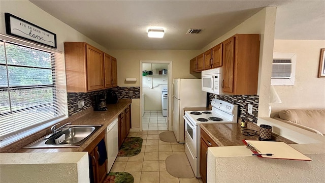 3282 NW 13th St, Lauderhill, FL 33311 - kitchen with a sink, visible vents, white appliances, and brown cabinetry