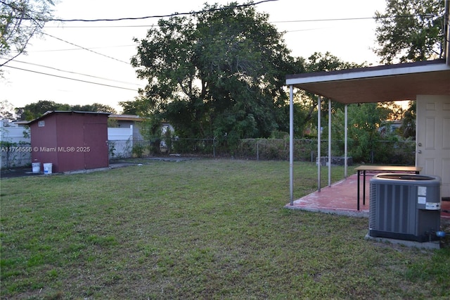 view of yard featuring a patio, fence, and central air condition unit