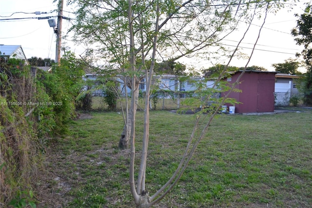 view of yard with fence and an outdoor structure