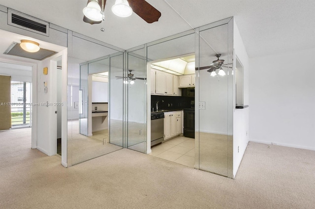 unfurnished bedroom featuring light carpet, a sink, and visible vents