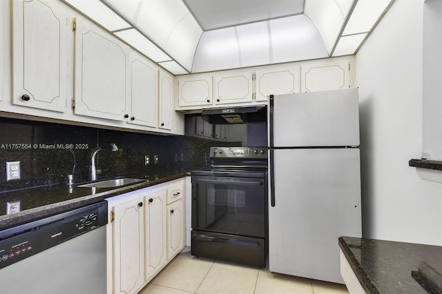 kitchen featuring black range with electric stovetop, freestanding refrigerator, a sink, dishwasher, and under cabinet range hood