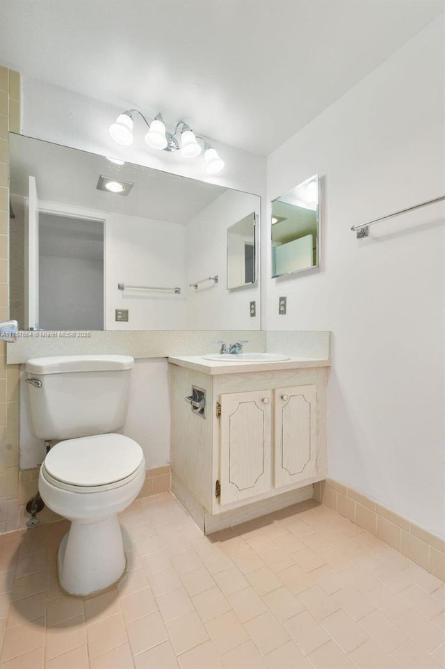 bathroom featuring vanity, toilet, and tile patterned floors