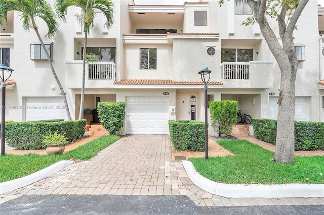 21375 Marina Cove Cir Unit 14-A, Aventura, FL 33180 - multi unit property with decorative driveway, an attached garage, a tile roof, and stucco siding