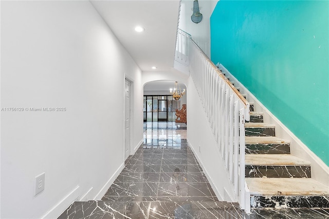 21375 Marina Cove Cir Unit 14-A, Aventura, FL 33180 - staircase with baseboards, arched walkways, marble finish floor, an inviting chandelier, and recessed lighting