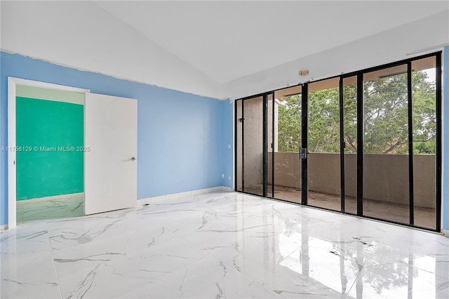 21375 Marina Cove Cir Unit 14-A, Aventura, FL 33180 - empty room with lofted ceiling, marble finish floor, and baseboards