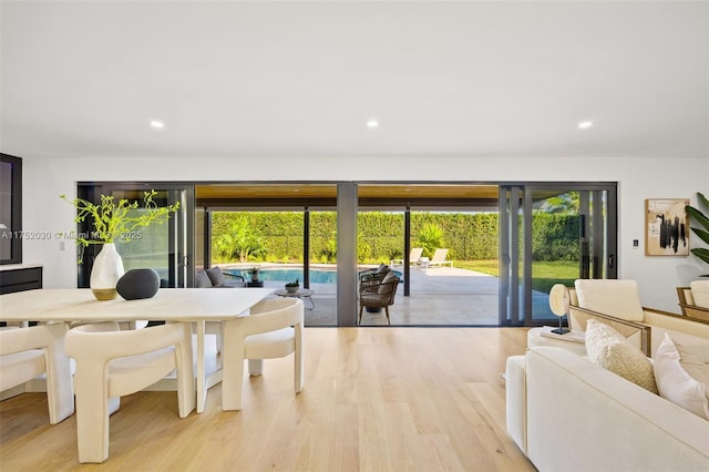 dining space with wood finished floors and recessed lighting