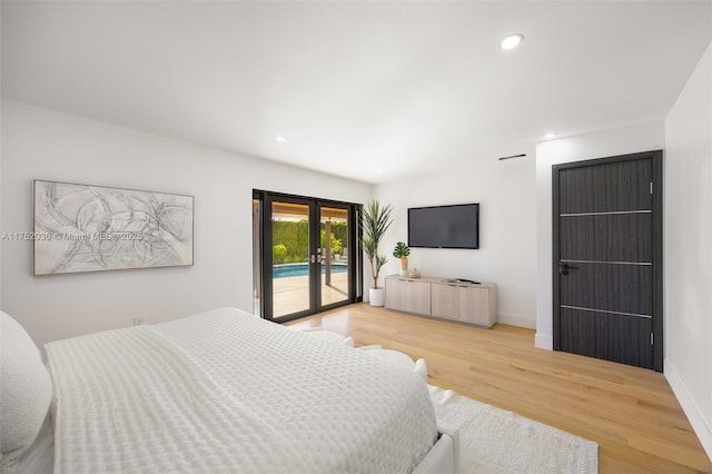 bedroom featuring access to exterior, french doors, recessed lighting, wood finished floors, and baseboards