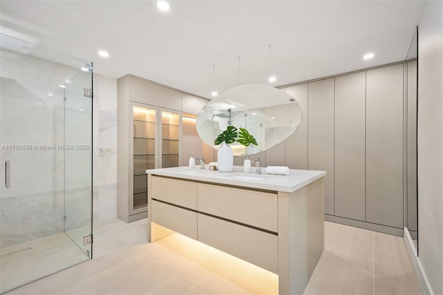 bathroom featuring a sink, recessed lighting, tile patterned flooring, and a shower stall