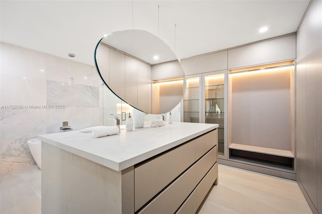 full bathroom featuring tile walls and vanity