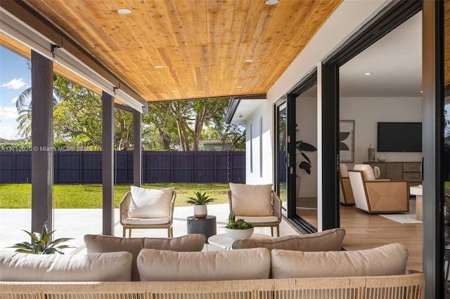 sunroom with a wealth of natural light and wood ceiling