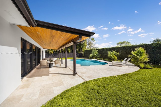 view of swimming pool with a yard, a patio area, a fenced backyard, and a fenced in pool