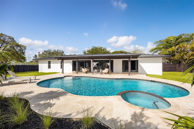 view of pool with a patio area, a lawn, and a fenced backyard