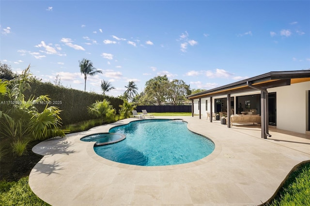 view of pool featuring a patio, a fenced backyard, and a pool with connected hot tub