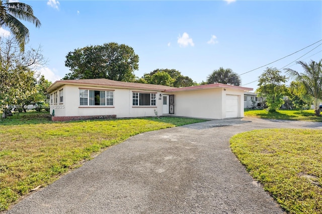 ranch-style home with a front lawn, driveway, and stucco siding