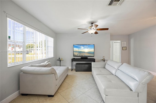 living room with light tile patterned floors, baseboards, visible vents, and ceiling fan