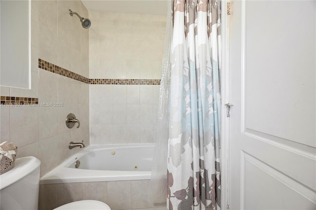 bathroom featuring toilet, tile walls, and tiled shower / bath combo