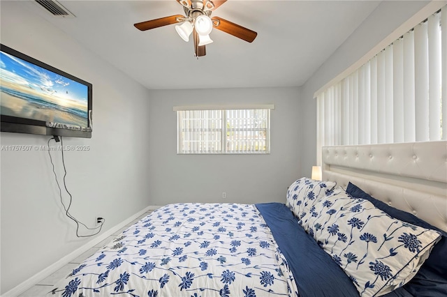 bedroom with visible vents, baseboards, and ceiling fan