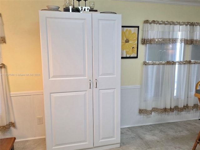interior space with a wainscoted wall